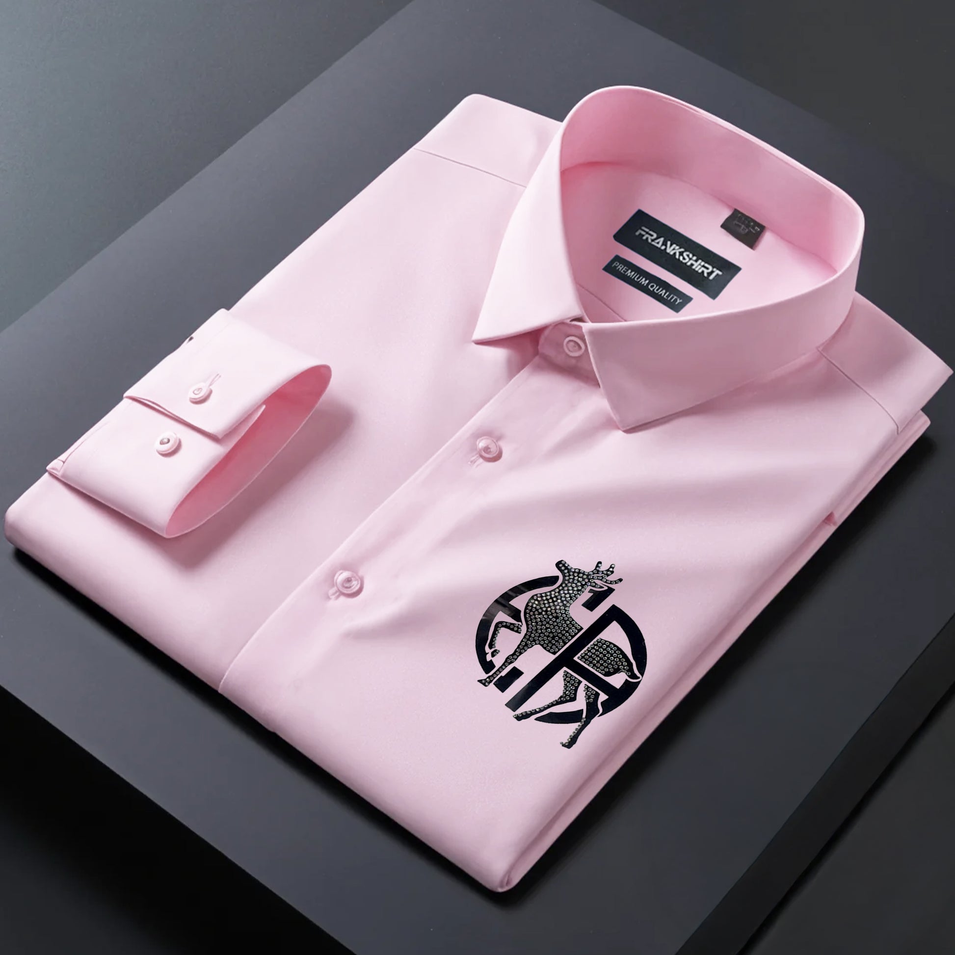 Pink dress shirt with a logo on a dark surface