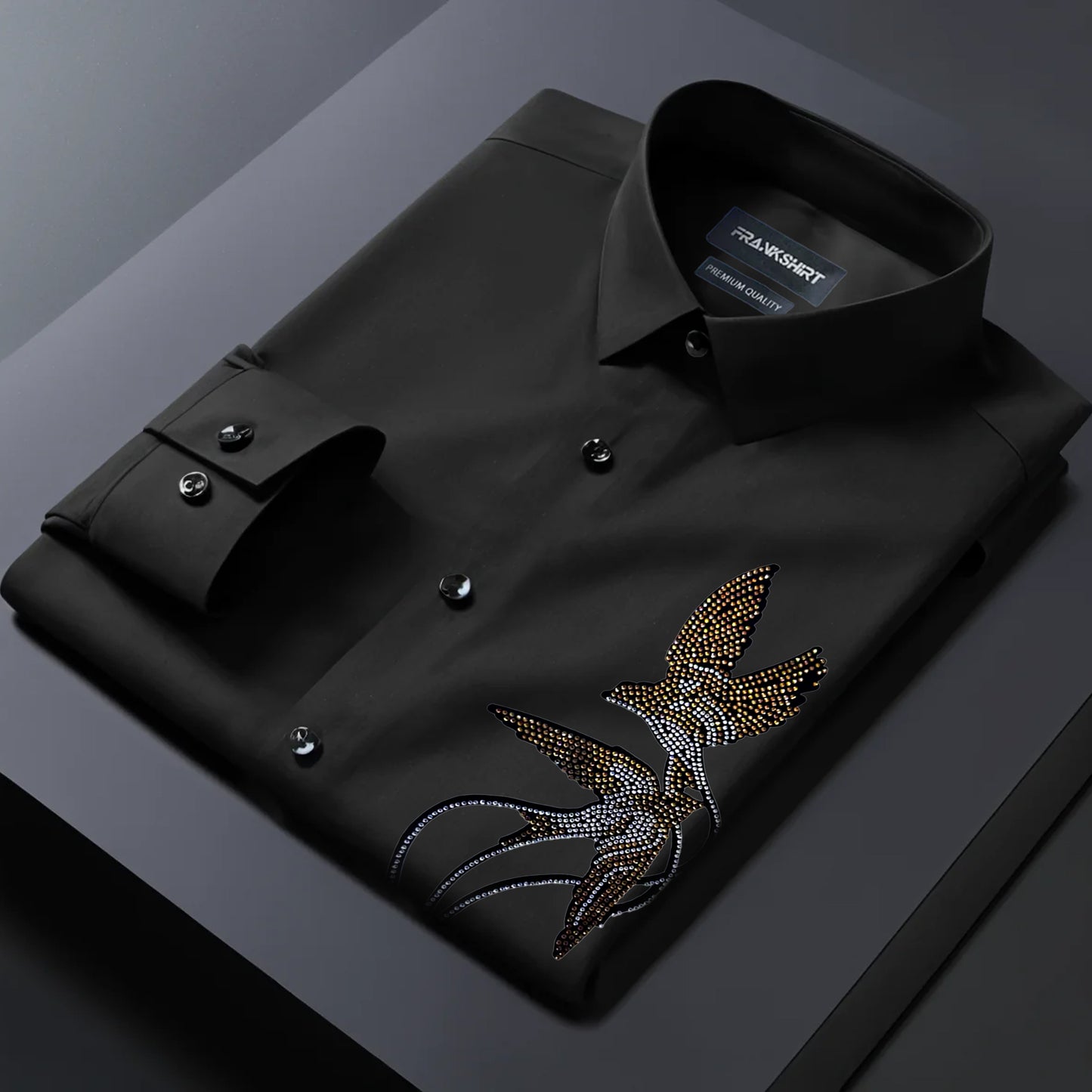 Black dress shirt with a decorative emblem on a dark background