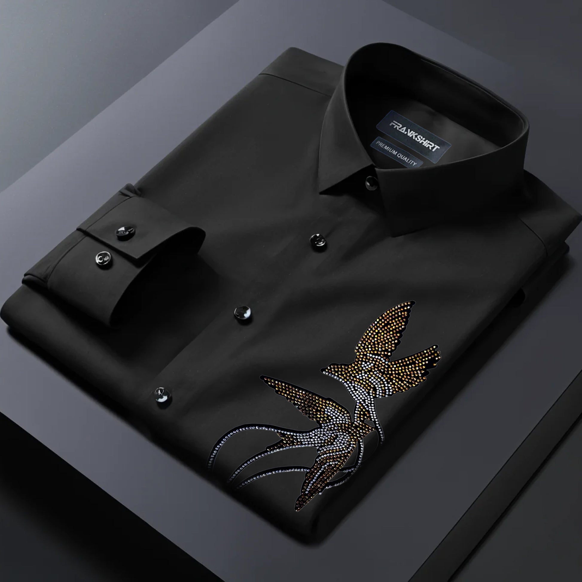 Black dress shirt with a decorative emblem on a dark background