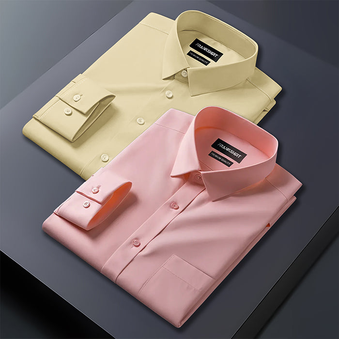 Two folded dress shirts, one yellow and one pink, on a dark surface.