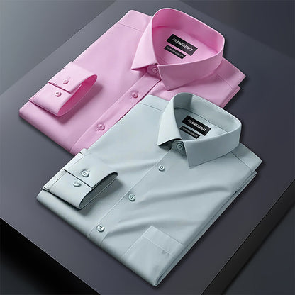 Pink and light blue dress shirts on a dark surface