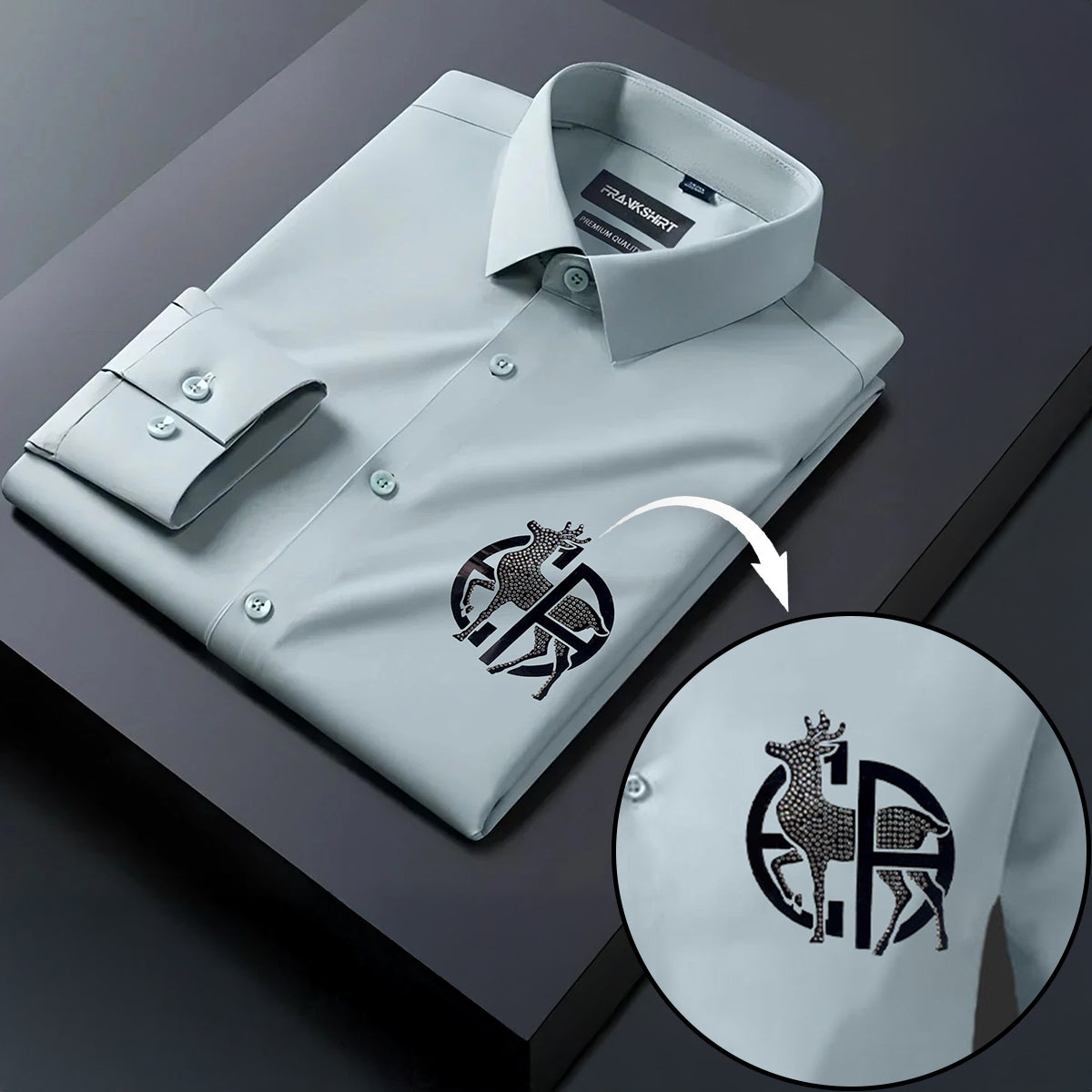 Light gray dress shirt with a detailed logo on a dark surface