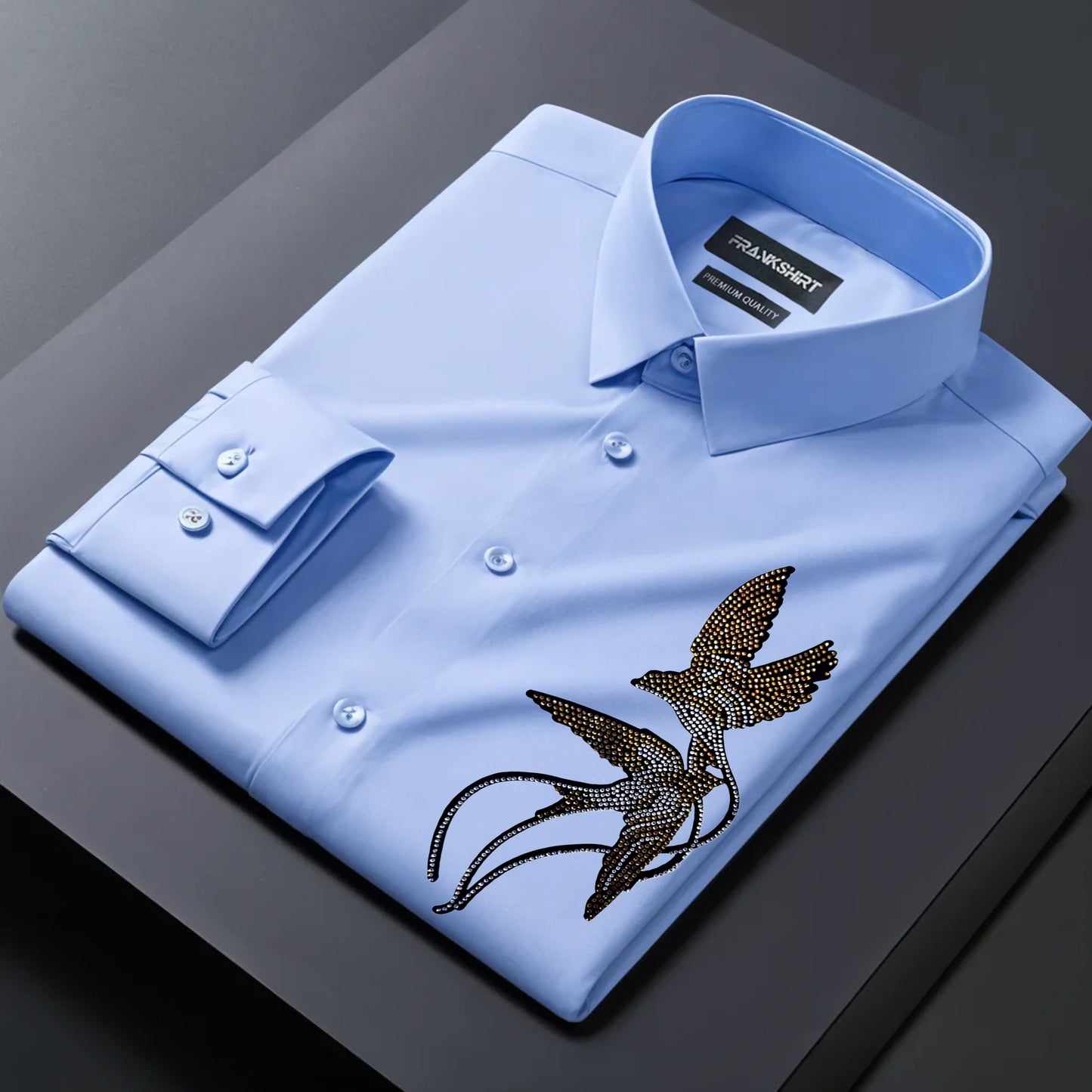 Blue dress shirt with bird embroidery on a dark surface