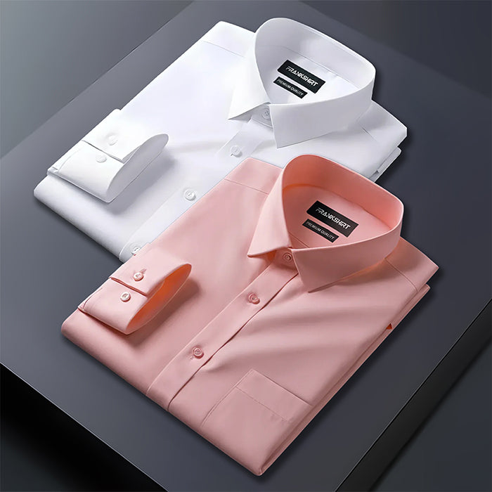 Two folded dress shirts, one white and one pink, on a dark surface with a brand label visible.
